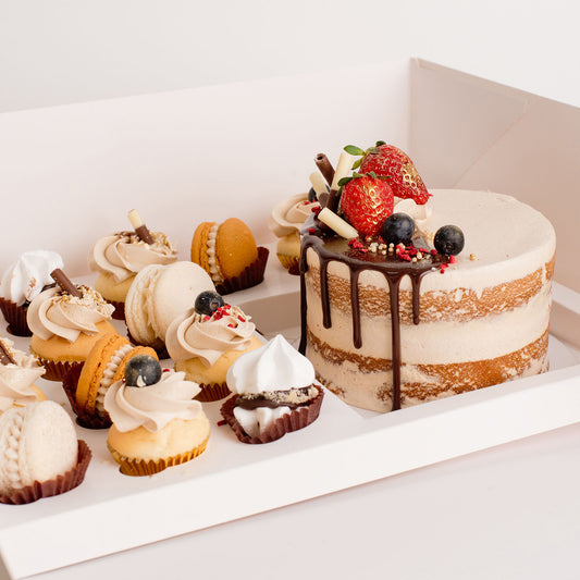 Cute cake and cupcake pack. Semi-naked caramel mini cake with gorgeous buttercream icing, seasonal fruit, chocolate sail and delicious dripping gold. Plus mini cupcakes, meringue kisses and macarons. Ideal for work and corporate party celebrations. Cute Cakes & Co, Cute Cakes and Co, Brisbane online cake shop,