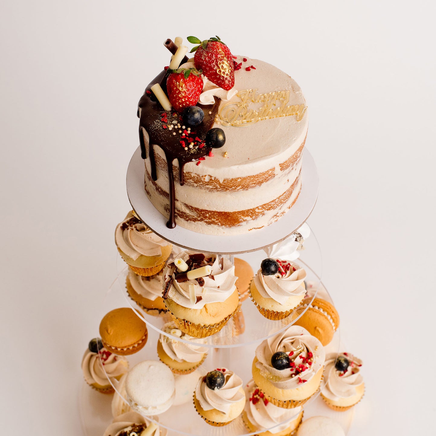 Cute cake and cupcake pack. Semi-naked caramel mini cake with gorgeous buttercream icing, seasonal fruit, chocolate sail and delicious dripping gold. Plus mini cupcakes, meringue kisses and macarons. Ideal for work and corporate party celebrations. Cute Cakes & Co, Cute Cakes and Co, Brisbane online cake shop,