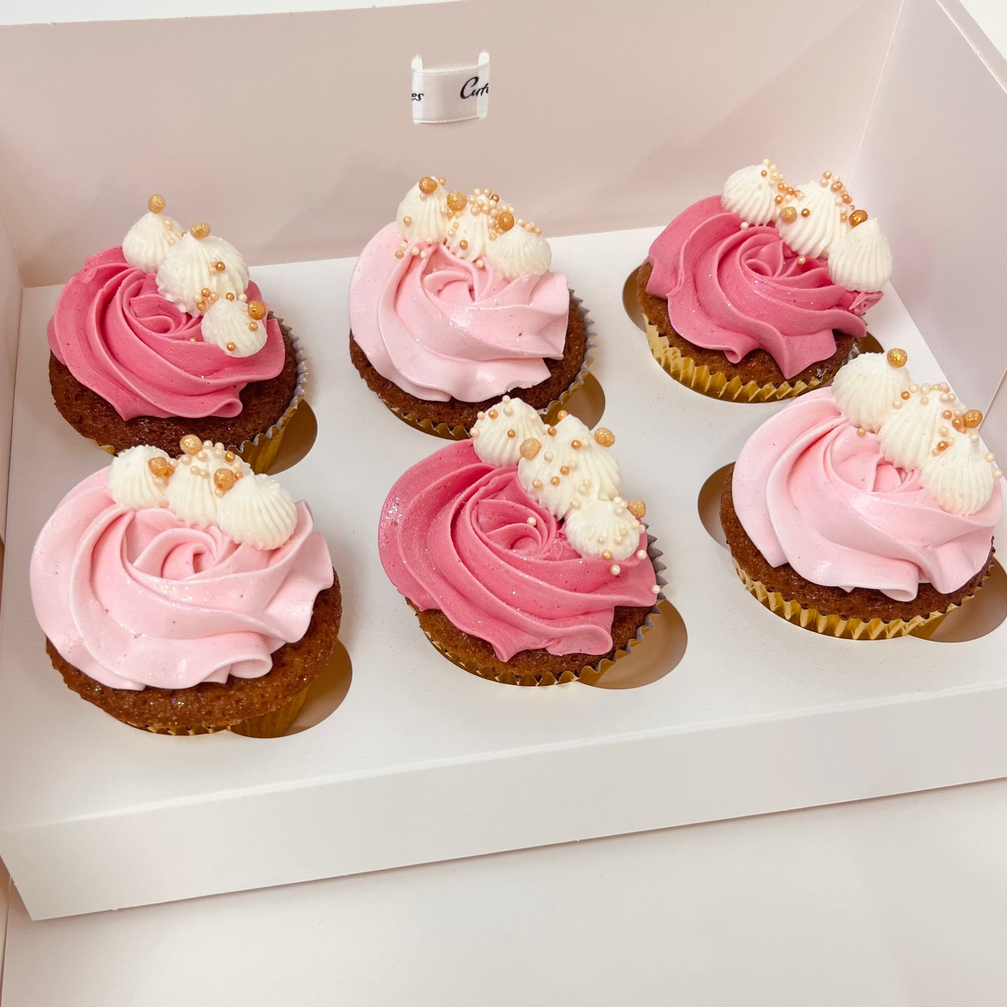 6 pack of delicious Gluten free salted caramel cupcakes with light pink and darker pink buttercream with white and gold detail. Made by Cute Cakes and Co. Brisbane cake shop near you. Same day orders. We deliver to your door