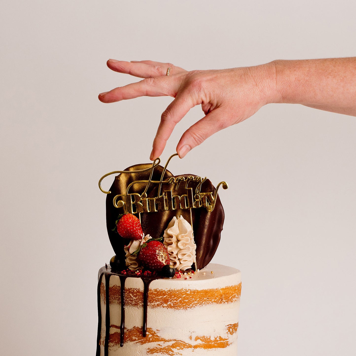 Semi-naked caramel layered cake looks and tastes gorgeous with its buttercream icing, seasonal fruit, chocolate sail and delicious dripping gold. Cute Cakes & Co, Cute Cakes and Co