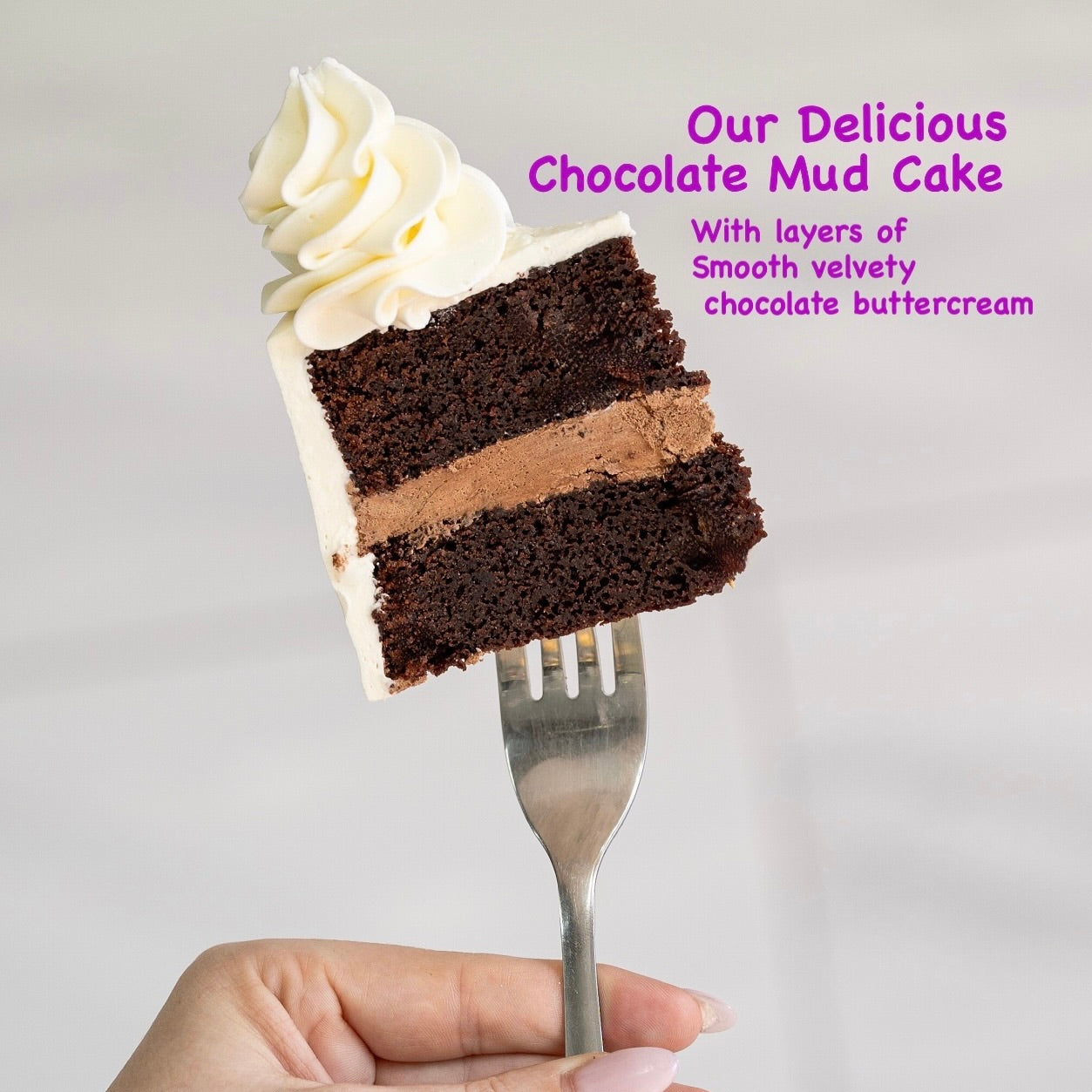 Slice of chocolate mud cake with white frosting on a fork. Our chocolate mud cake delicious Made by Cute Cakes and co. Brisbane base cake shop