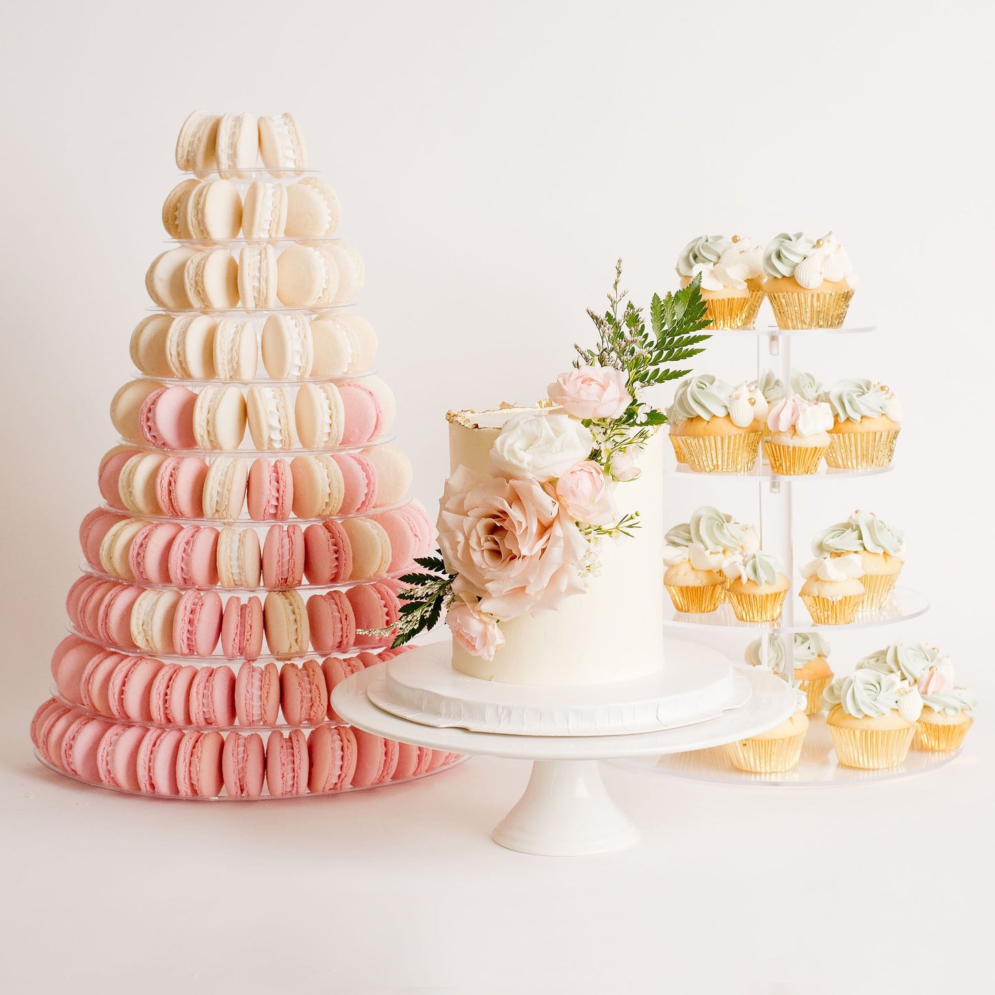 wedding setup display with a single tier wedding cake with fresh flowers on it. pink and white macaron tower . cupcake stand with sage green and white cupcake Beautiful birthday cakes and cupcakes, Cute Cakes and Co, Brisbane