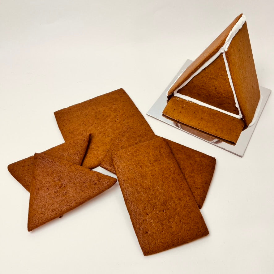 Gingerbread cookies shaped like a house on a white background