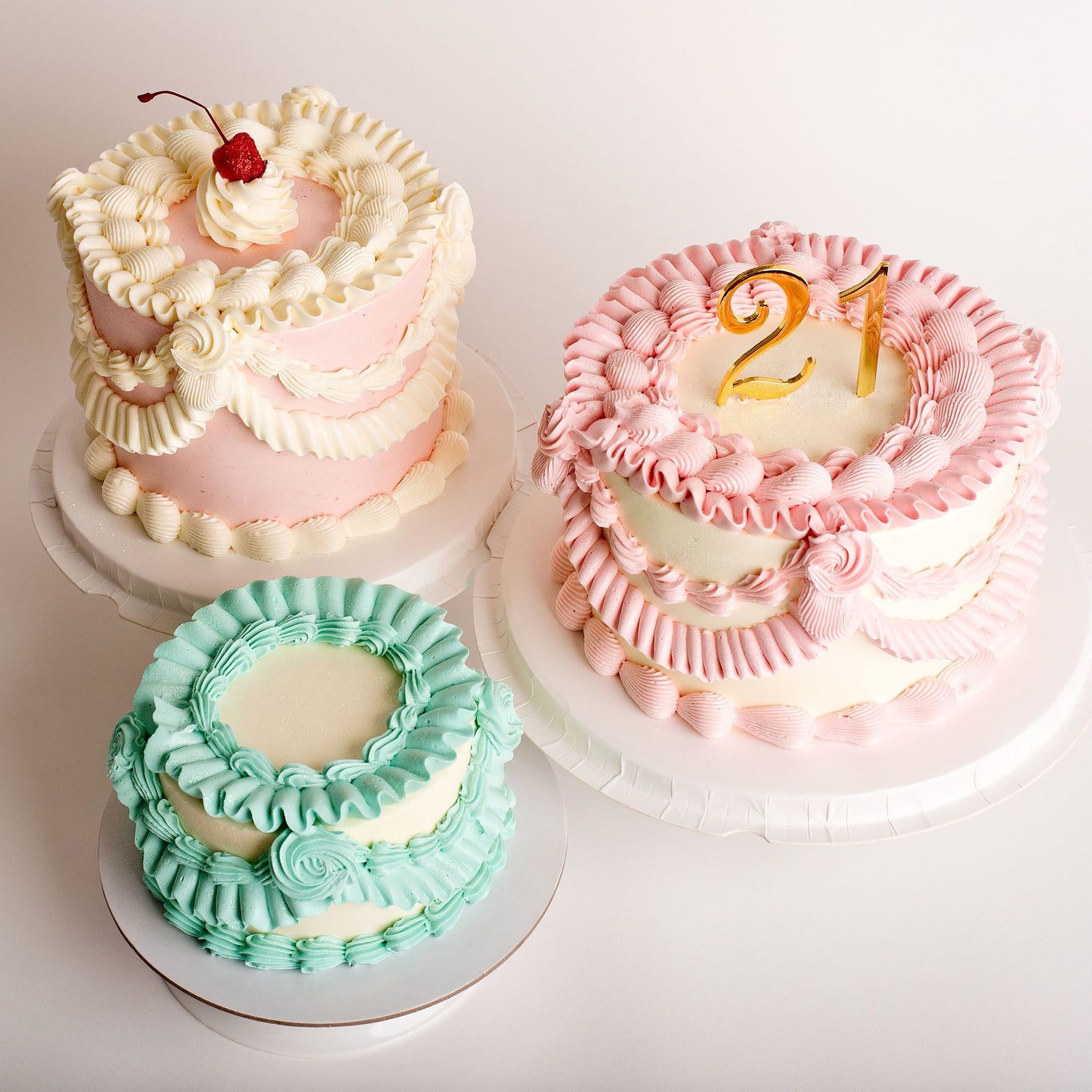top view of 3 Hand-piped vintage mini cake with custom colours
