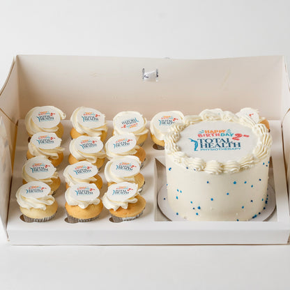 A custom logo birthday cake, with 15 mini cupcakes, all decorated with a 'Total Health' logo. 
