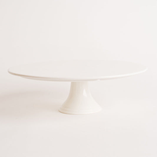 A white, round, single-tier porcelain cake stand with a flat surface and pedestal base. Beautiful birthday cakes and cupcakes, Cute Cakes and Co, Brisbane 