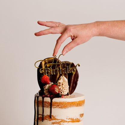 Semi-naked caramel layered cake looks and tastes gorgeous with its buttercream icing, seasonal fruit, chocolate sail and delicious dripping gold. Cute Cakes & Co, Cute Cakes and Co