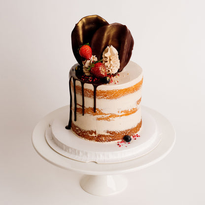 Semi-naked caramel layered cake looks and tastes gorgeous with its buttercream icing, seasonal fruit, chocolate sail and delicious dripping gold. Cute Cakes & Co, Cute Cakes and Co