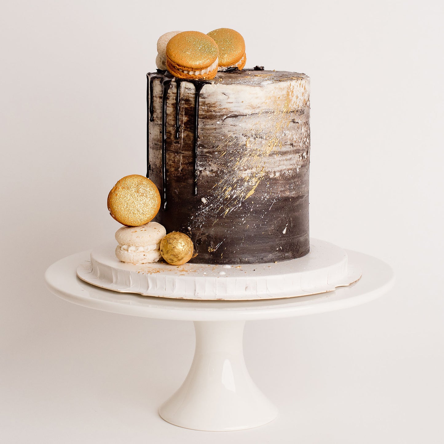 Black, white and gold theme Cake with macarons 
Looks fabulous, Made with love by Cute Cakes and Co. the 5 star review cake shop, in Brisbane.