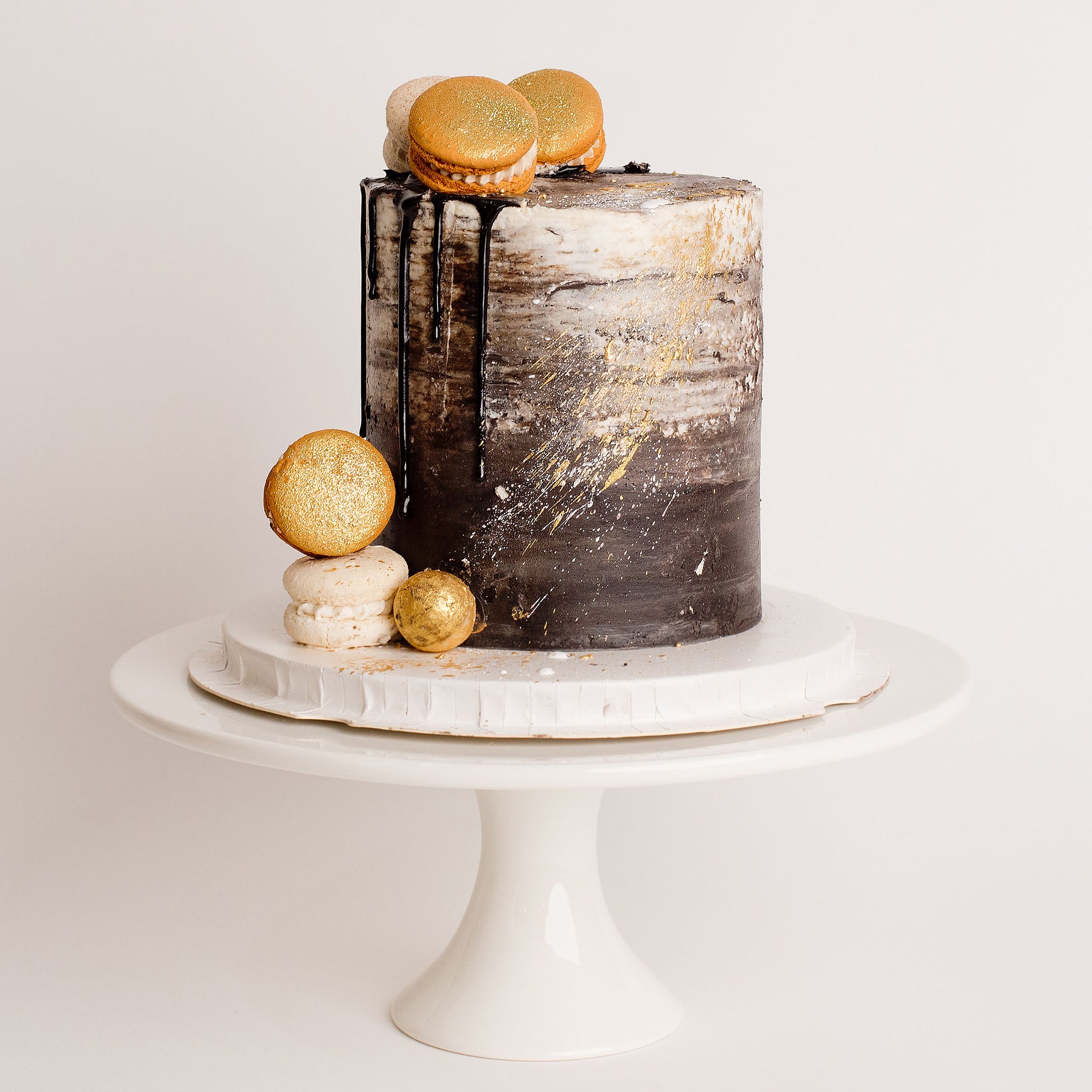 Black, white and gold theme Cake with macarons 
Looks fabulous, Made with love by Cute Cakes and Co. the 5 star review cake shop, in Brisbane.