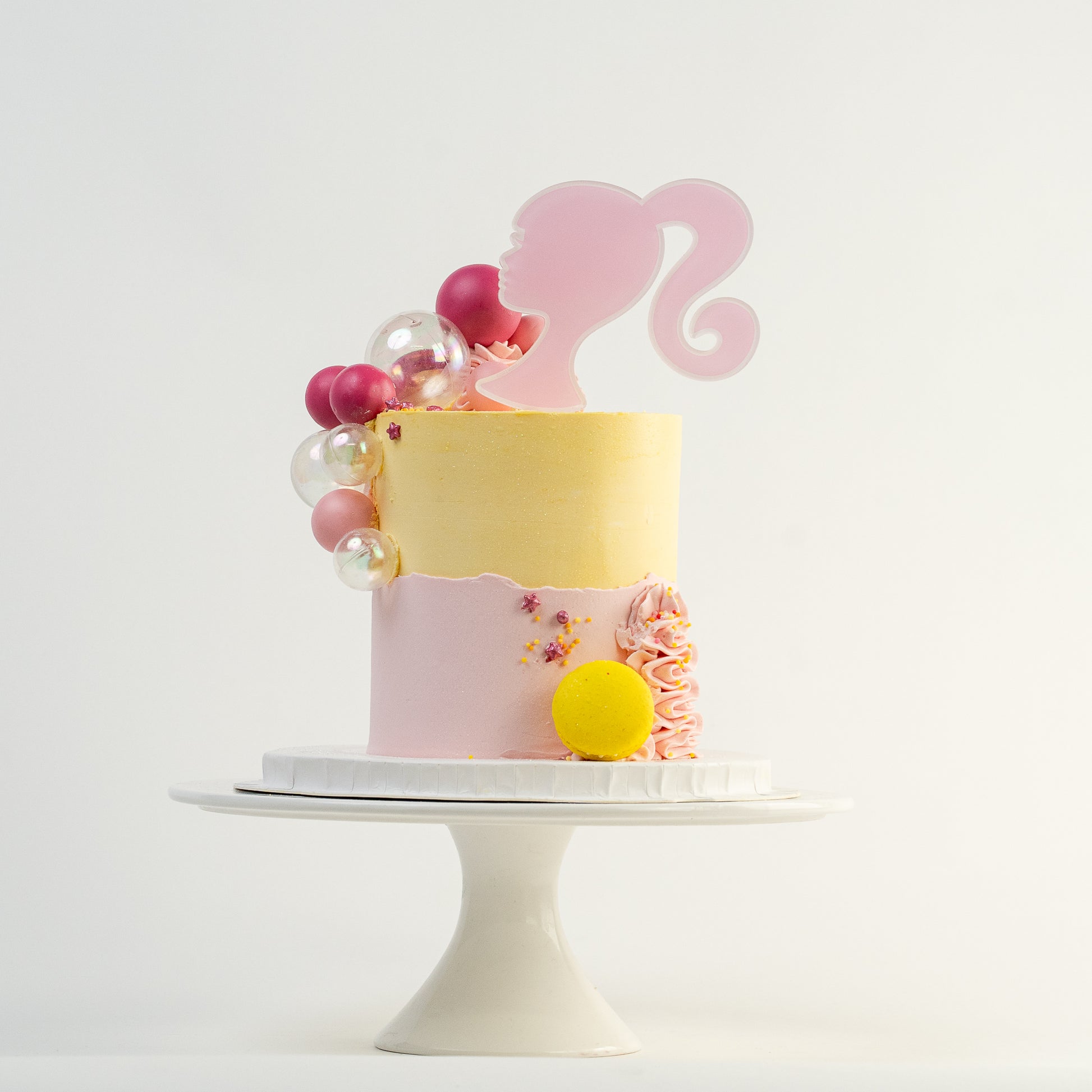 Pretty pink and yellow cake with a side decoration of shades of pink and clear balls. Wiggle and yellow macaron at the base. glitter perfect for a  girl's birthday Looks fabulous.  Made with love by Cute Cakes & Co, Brisbane Favourite cake shop. 
5 star review cake shop in Brisbane. 