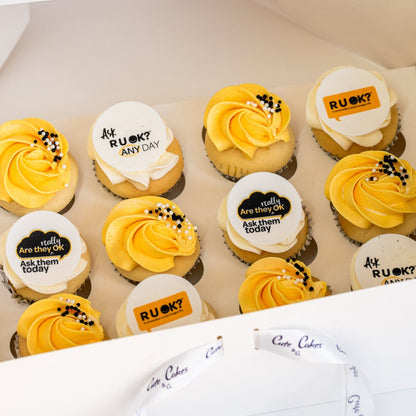 Mini cupcakes with yellow and white butterceam, some with black sprinkles and edible disks with 'R U OK?' text on them. RU Ok day, Cute Cakes and Co, Brisbane cake shop, 