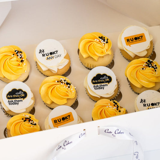 Mini cupcakes with yellow and white butterceam, some with black sprinkles and edible disks with 'R U OK?' text on them. RU Ok day, Cute Cakes and Co, Brisbane cake shop, 