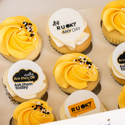 Mini cupcakes with yellow and white butterceam, some with black sprinkles and edible disks with 'R U OK?' text on them. RU Ok day, Cute Cakes and Co, Brisbane cake shop, 
