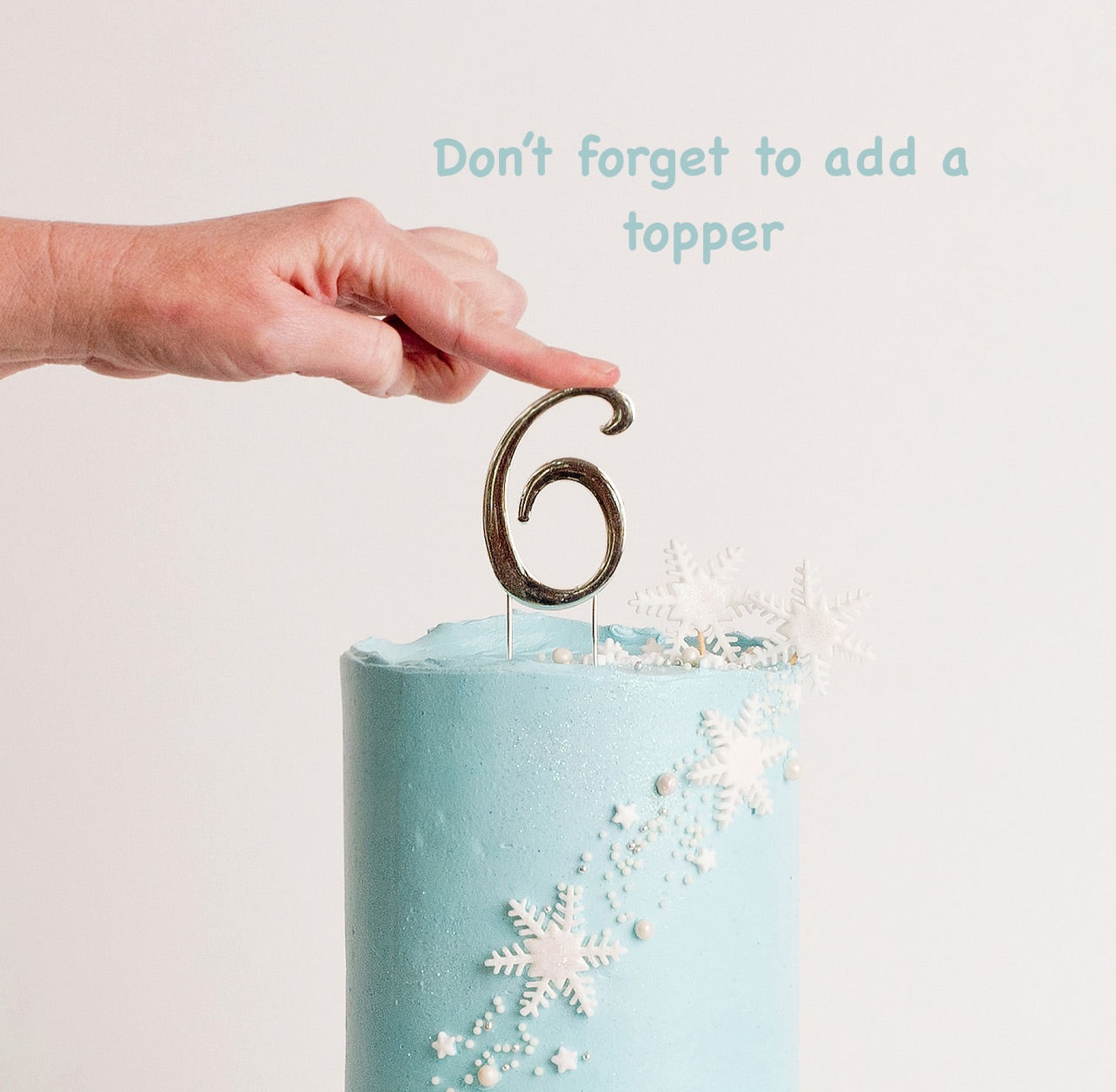 Disney Frozen themed birthday cake iced in light blue buttercream with snowflakes stars and glitter perfect for a little girl's birthday Looks fabulous.   Made with love by the five star cake shop ,Cute Cakes and Co, Brisbane.  Mitchelton , Cake shop near you 