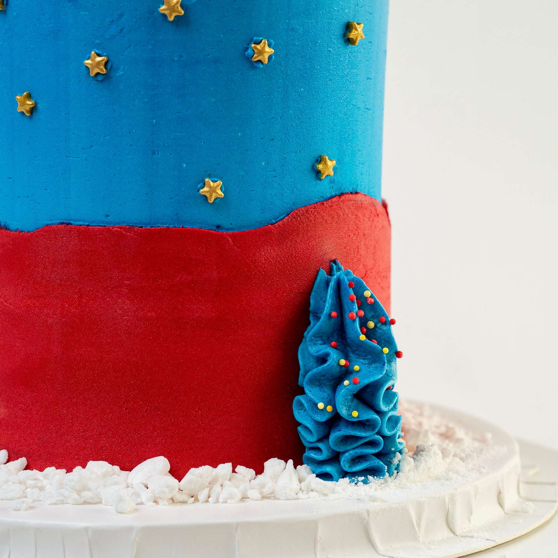 Close up of the base of the Superhero themed cake blue and red buttercream gold stars  Made with love by Cute Cakes & Co, Brisbane Favourite cake shop. 
5 star review cake shop in Brisbane. 