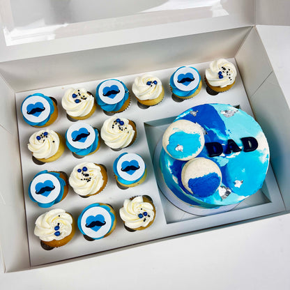 Mini Cake and cupcake in a pack. decorated in blues and white. Dad wording on the cake matching with heart and mustache on the cupcakes 