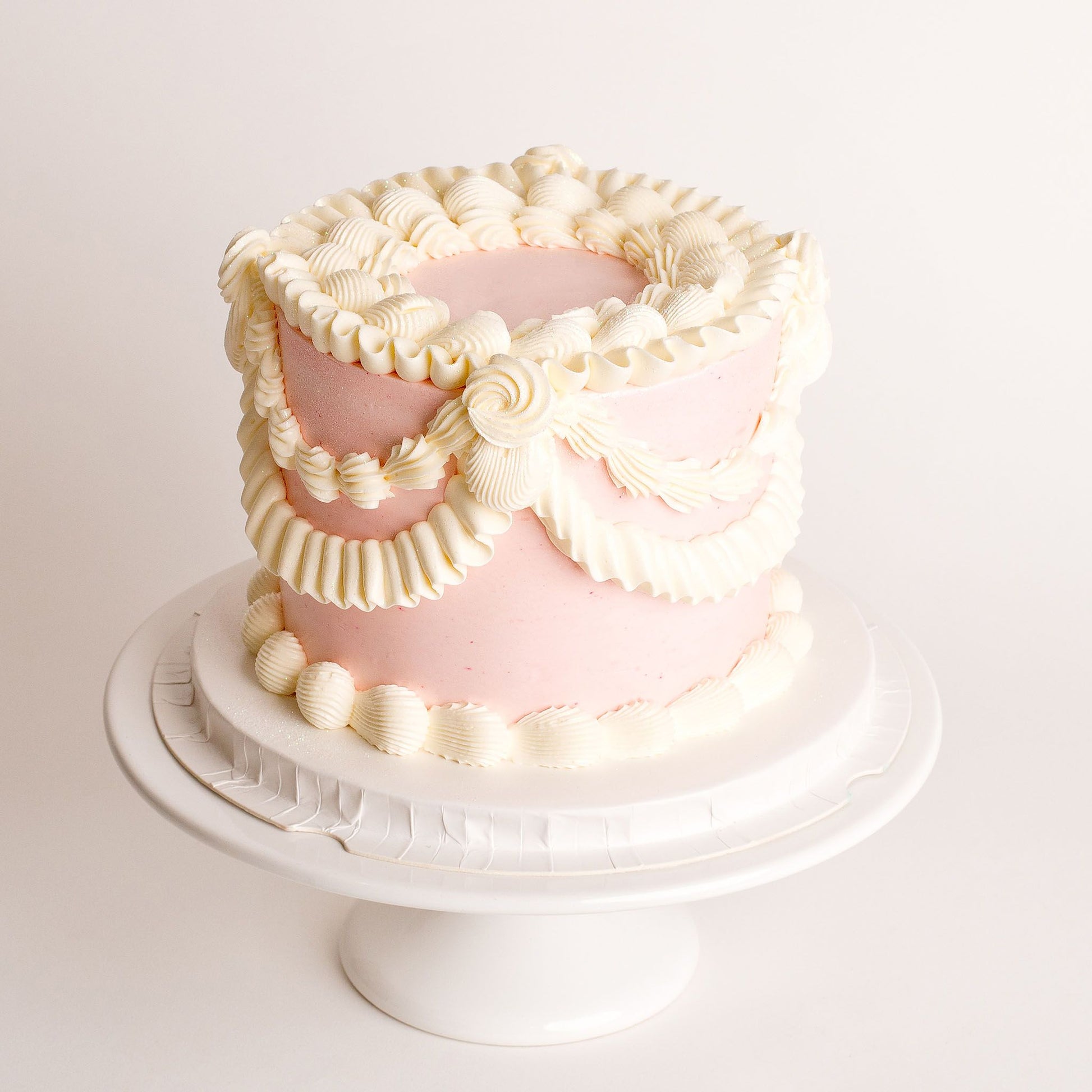 Mini vintage birthday cake with pink buttercream piping