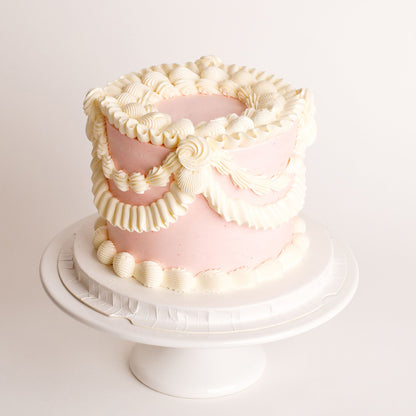 Mini vintage birthday cake with pink buttercream piping