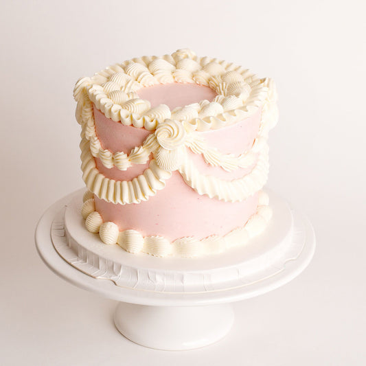 Mini vintage birthday cake with pink buttercream piping