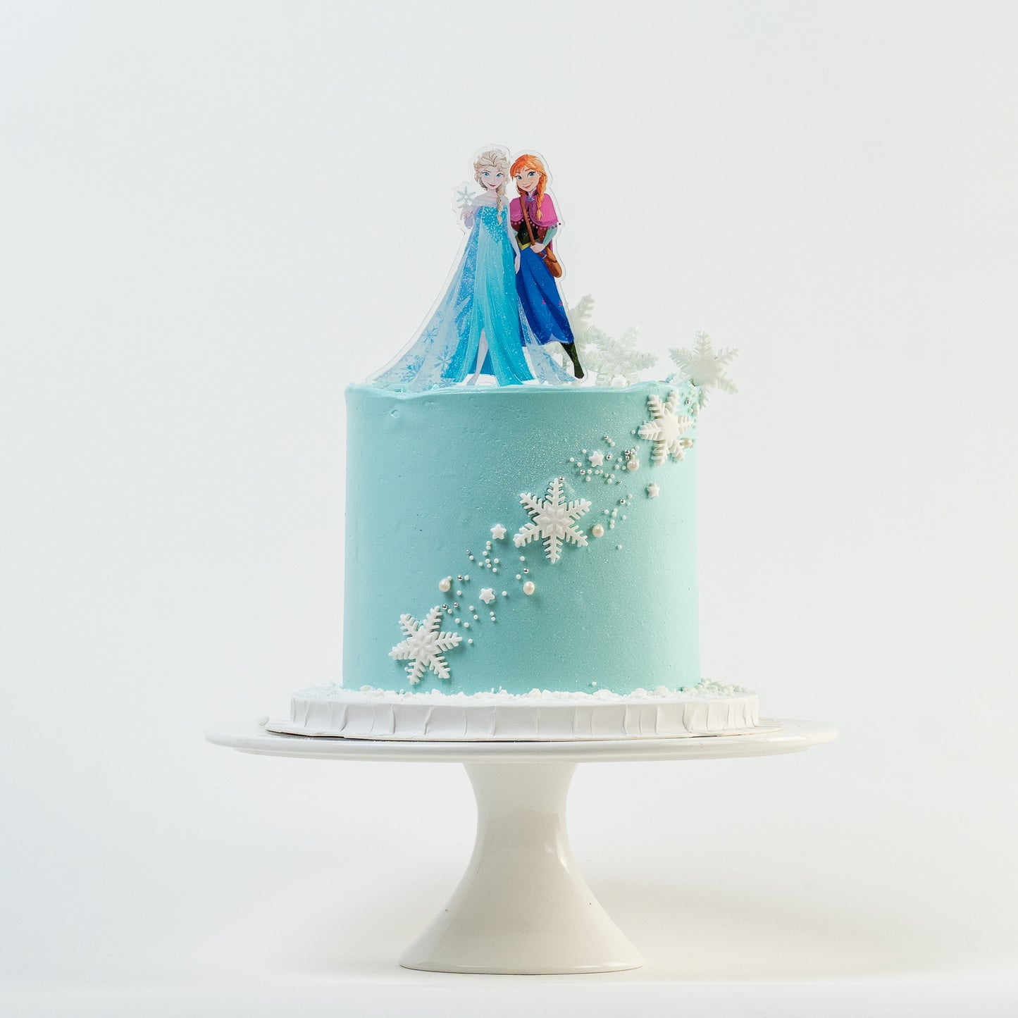  Disney Frozen themed birthday cake iced in light blue buttercream with snowflakes stars and glitter perfect for a little girl's birthday Looks fabulous.   Made with love by the five star cake shop ,Cute Cakes and Co, Brisbane.  Mitchelton , Cake shop near you 