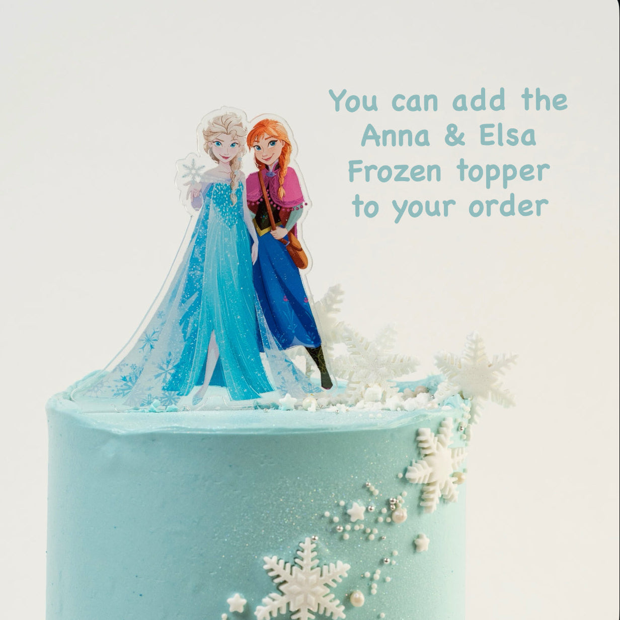 Disney Frozen themed birthday cake iced in light blue buttercream with snowflakes stars and glitter perfect for a little girl's birthday Looks fabulous.   Made with love by the five star cake shop ,Cute Cakes and Co, Brisbane.  Mitchelton , Cake shop near you 