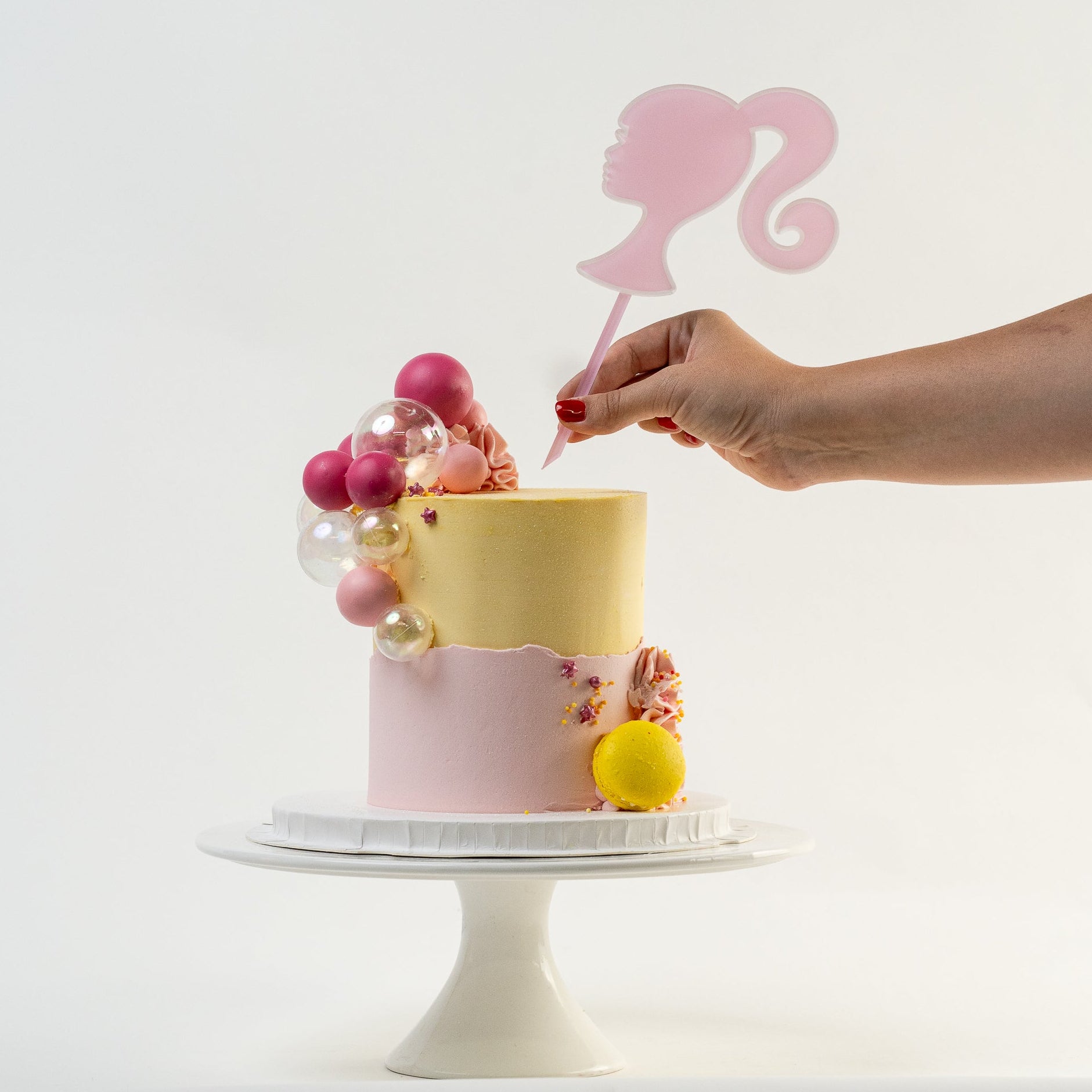 Hand placing a Barbie cake topper Looks fabulous.   Made with love by Cute Cakes & Co, Brisbane Favourite cake shop. 
5 star review cake shop in Brisbane. 
