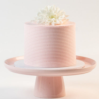 Light pink cake, decorated with ribbed buttercream feature on the sides and white fresh flowers on the top. Made with love by Brisbane’s favourite, 5 star cake shop, Cute Cakes & Co 