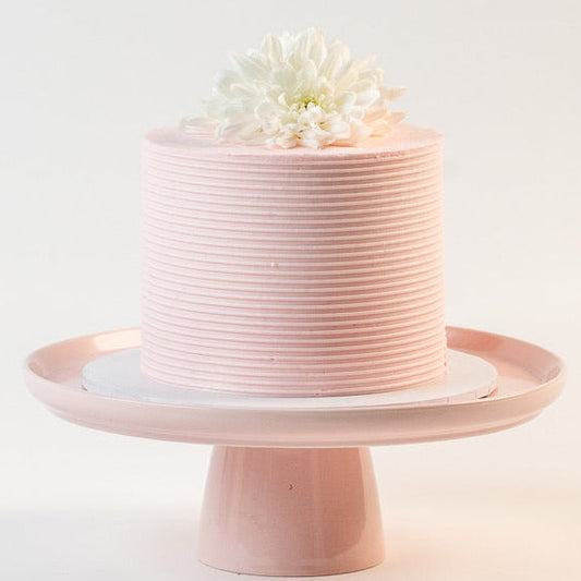 Light pink cake, decorated with ribbed buttercream feature on the sides and white fresh flowers on the top. Made with love by Brisbane’s favourite, 5 star cake shop, Cute Cakes & Co 