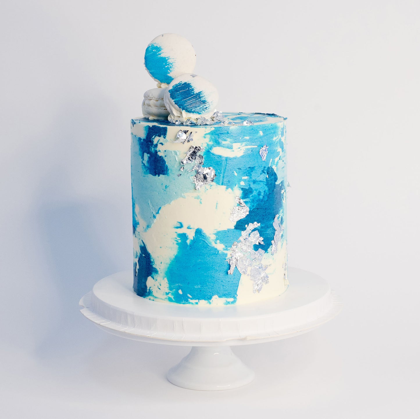 Maddox blue watercolour cake with silver leaf, white macarons and edible glitter