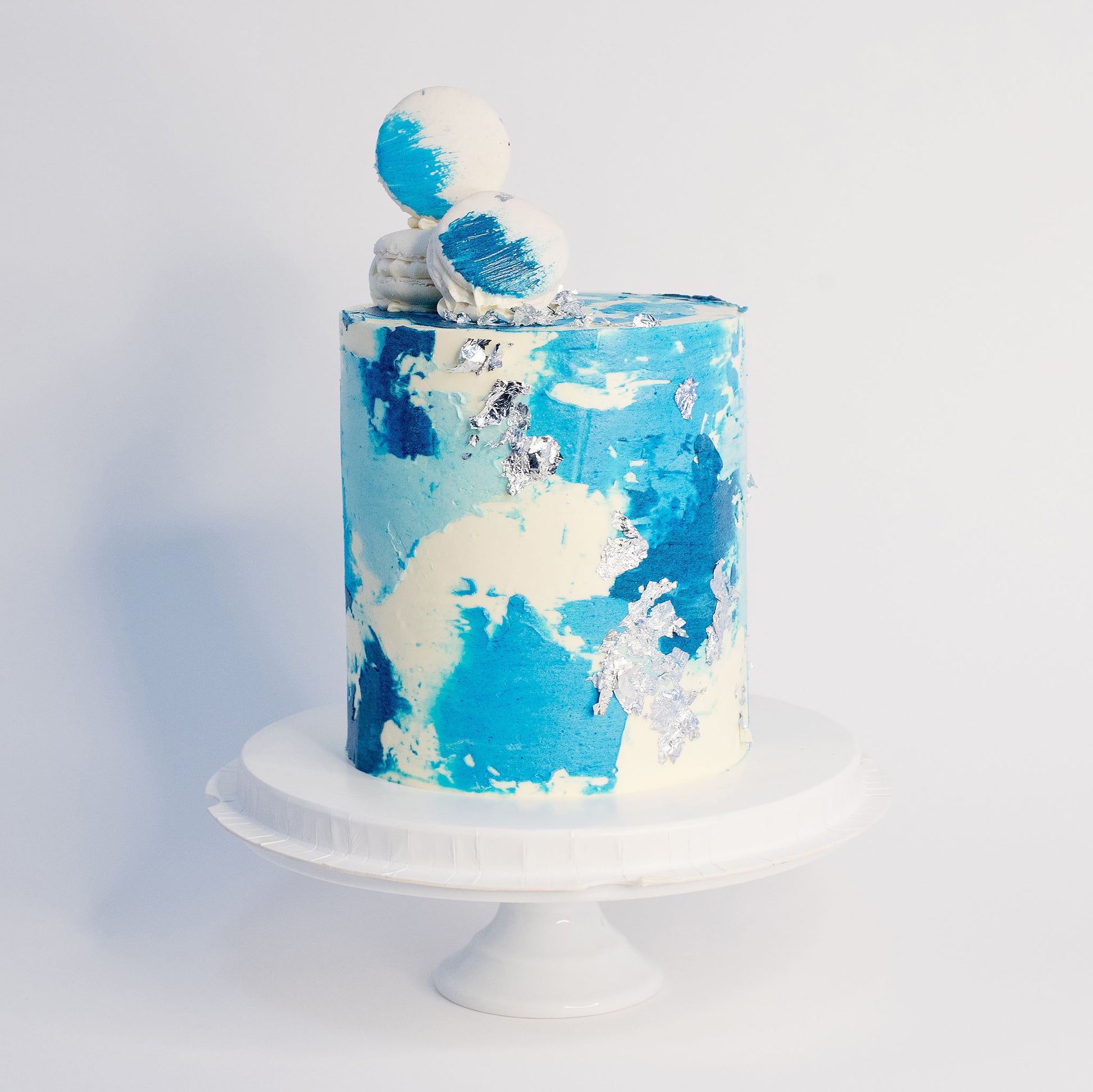 Maddox blue watercolour cake with silver leaf, white macarons and edible glitter