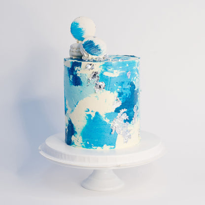 Maddox blue watercolour cake with silver leaf, white macarons and edible glitter
