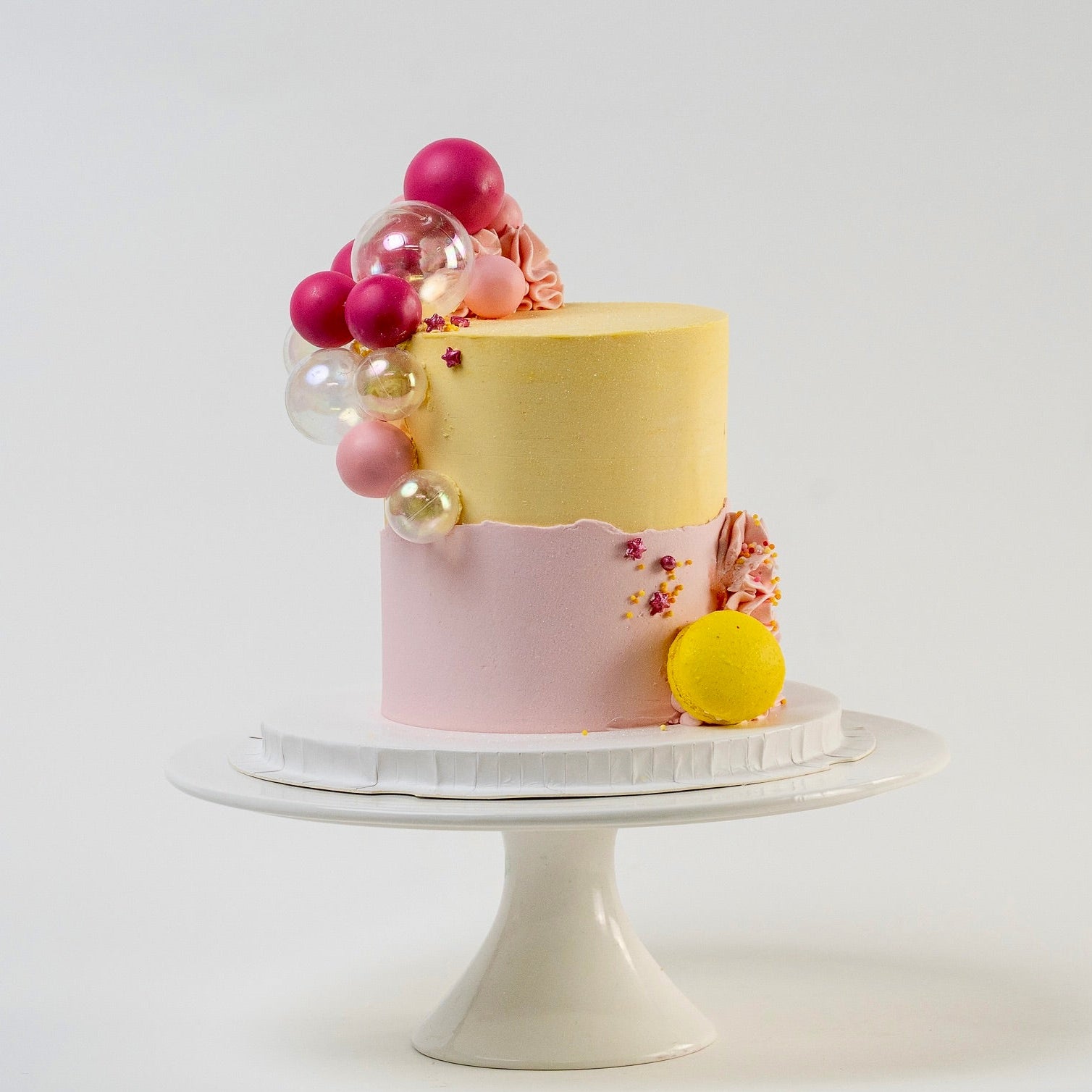 Pretty pink and yellow cake with a side decoration of shades of pink and clear balls. Wiggle and yellow macaron at the base. glitter perfect for a  girl's birthday Looks fabulous.  Made with love by Cute Cakes & Co, Brisbane Favourite cake shop. 
5 star review cake shop in Brisbane. 
