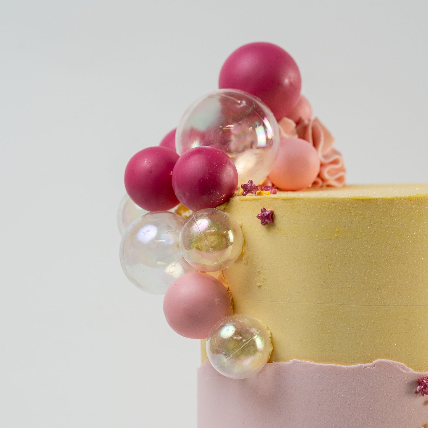  Pretty pink and yellow cake with a side decoration of shades of pink and clear balls. Wiggle and yellow macaron at the base. glitter perfect for a  girl's birthday Looks fabulous.  Made with love by Cute Cakes & Co, Brisbane Favourite cake shop. 
5 star review cake shop in Brisbane. 