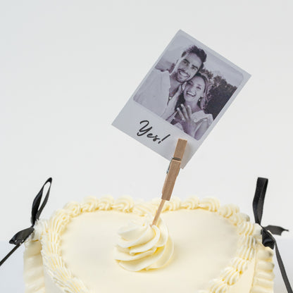 White cake with a photo of a couple and 'Yes!' text on a white background. White  Perfect for engagements. Made with love by Cute Cakes and Co. the 5 star cake shop, in Brisbane.