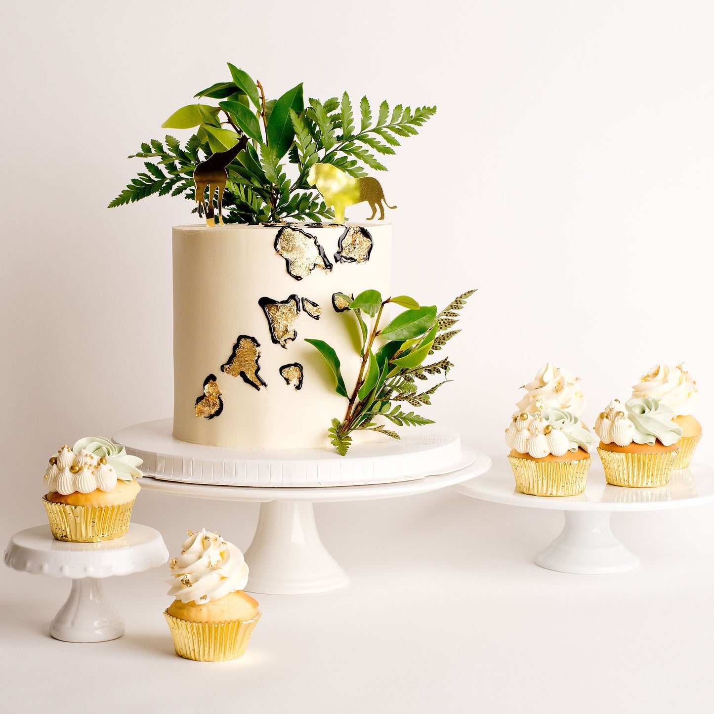 Cute Cakes and co, Cakes near me, Boys cakes, jungle cakes, gold leaf, wild one cake, Buttercream cakes, Gold animal toppers, matching cupcakes 