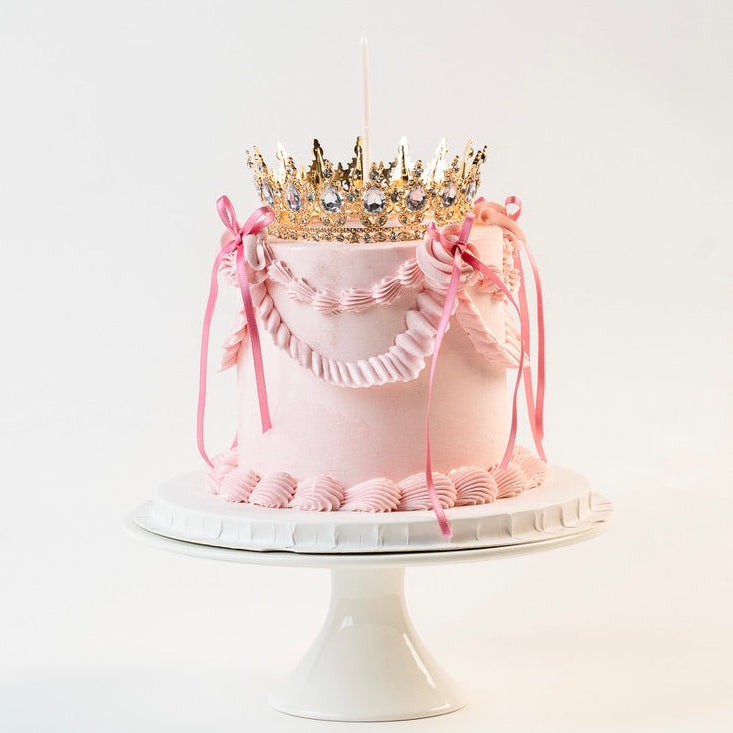Pink Vintage style birthday cake. Pink ribbon bow with a crown on the top and candle. Made with love by Brisbane’s favourite, 5 star cake shop, Cute Cakes & Co 