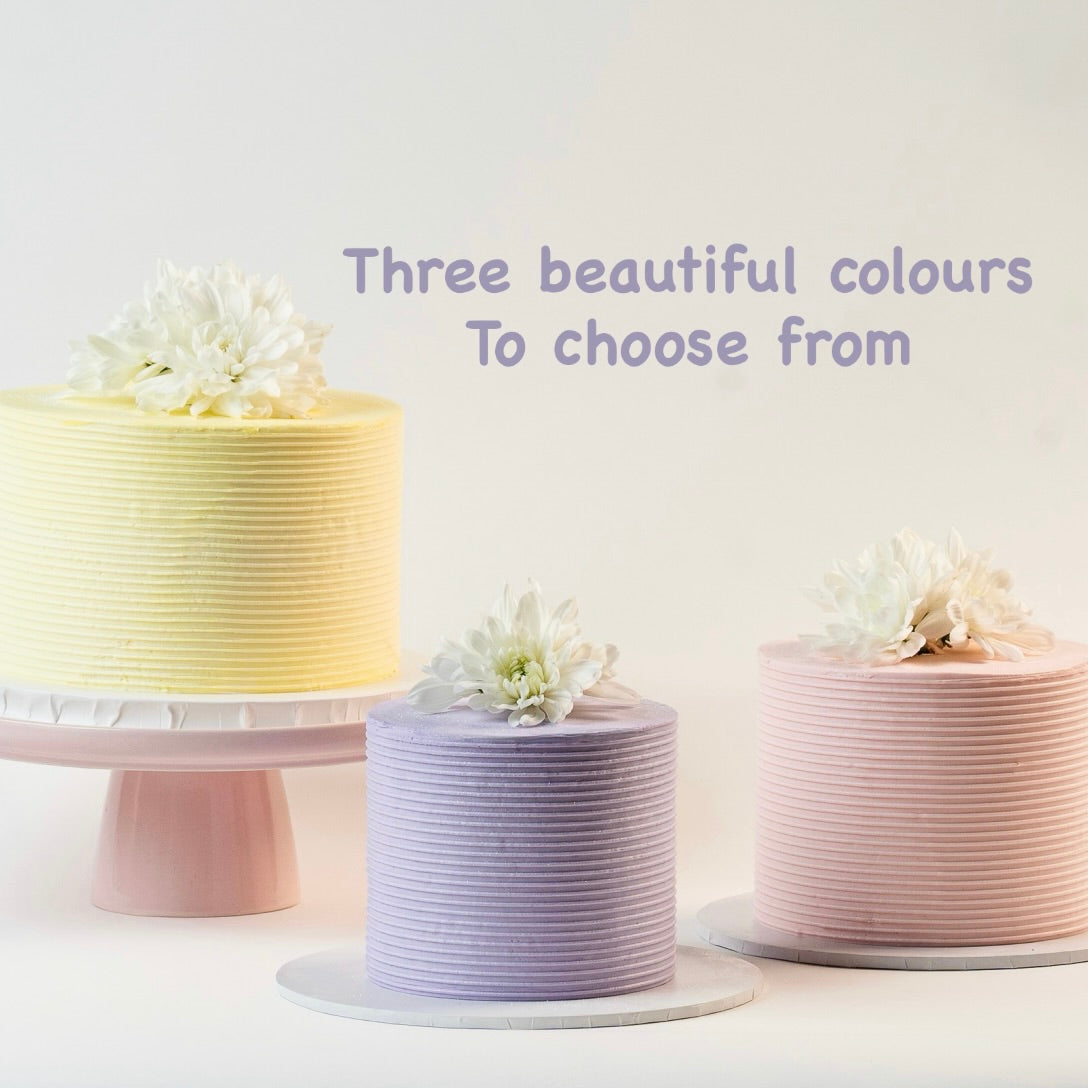 Light pink, Light Purple and Light yellow cakes, decorated with ribbed buttercream feature on the sides and white fresh flowers on the top. Made with love by Brisbane’s favourite, 5 star cake shop, Cute Cakes & Co 