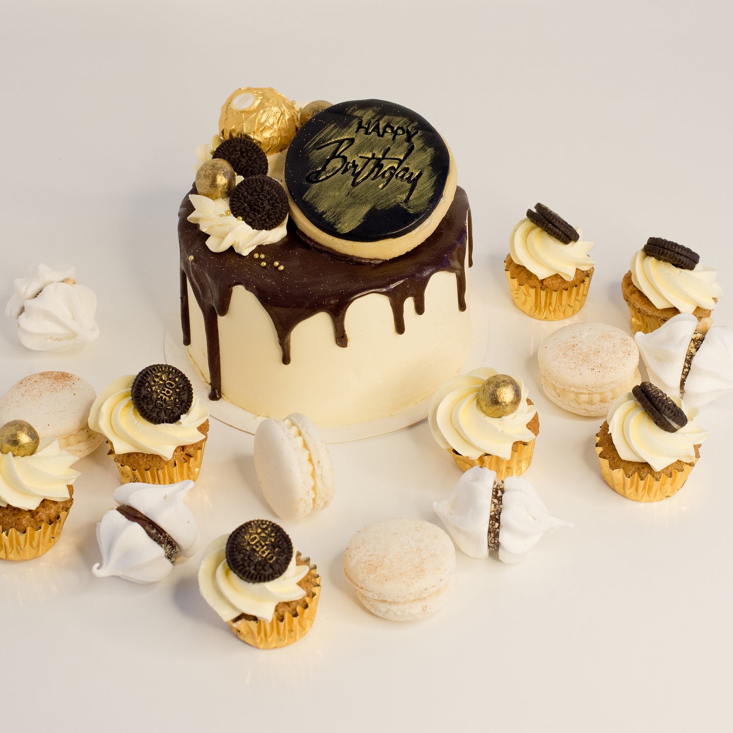 Cute cake and cupcake pack. This cake has silky chocolate dripping over vanilla buttercream icing. Plus mini cupcakes, meringue kisses and macarons. Ideal for work and corporate birthday celebrations. Cute Cakes & Co, Cute Cakes and Co, Brisbane online cake shop, Caxton Street cake shop