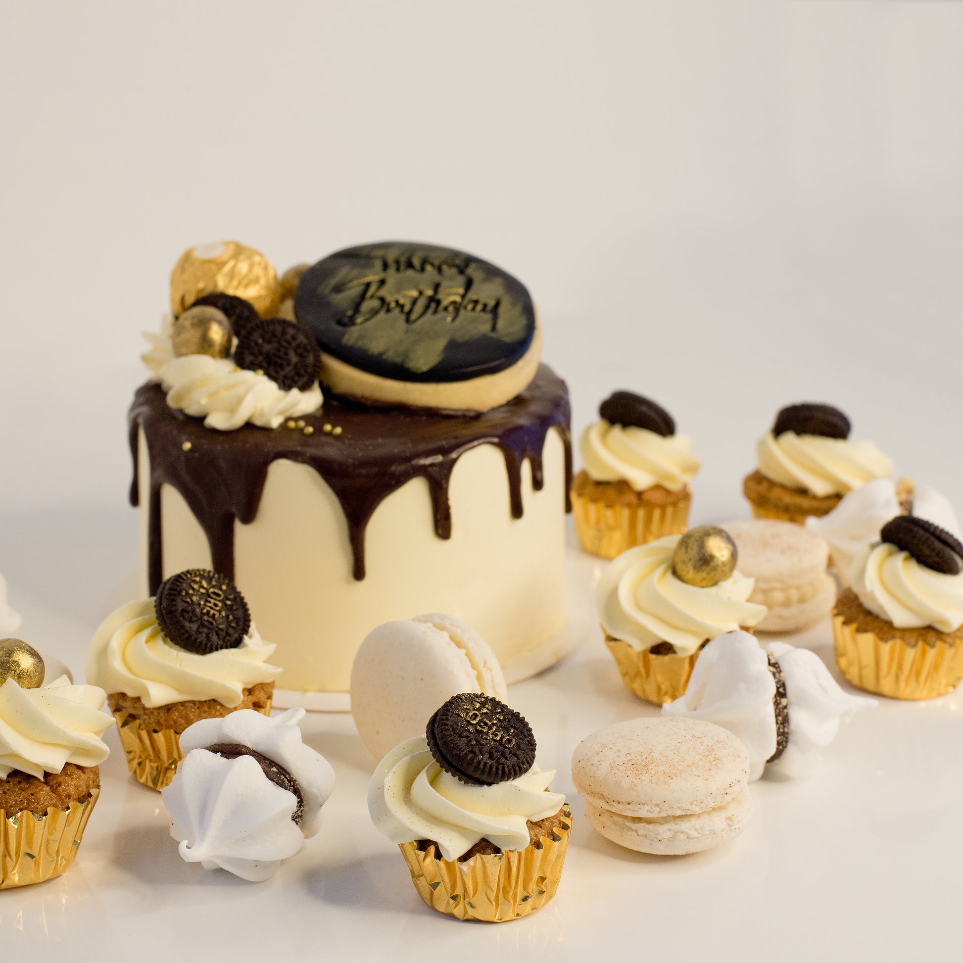 Cute cake and cupcake pack. This cake has silky chocolate dripping over vanilla buttercream icing. Plus mini cupcakes, meringue kisses and macarons. Ideal for work and corporate birthday celebrations. Cute Cakes & Co, Cute Cakes and Co, Brisbane online cake shop, Caxton Street cake shop