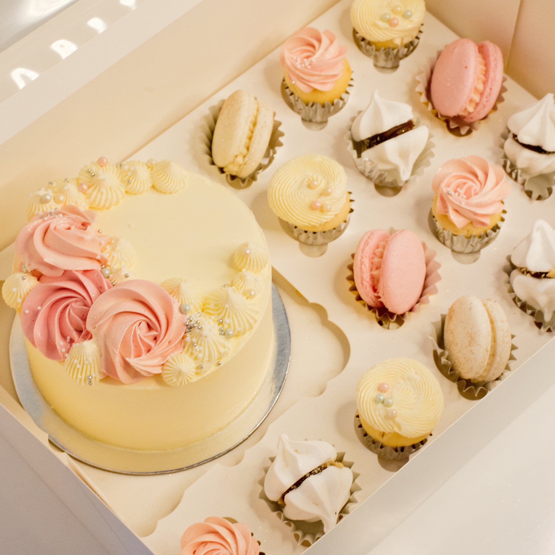 Cute cake and cupcake pack. Pretty pink and white cake decorated with tasty buttercream. Plus mini cupcakes, meringue kisses and macarons. Ideal for work and corporate birthday celebrations. Cute Cakes & Co, Cute Cakes and Co, Brisbane online cake shop, Caxton Street cake shop