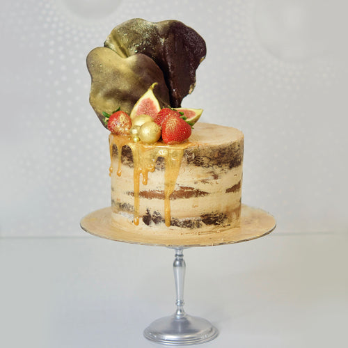 With semi-naked caramel layered cake looks and tastes gorgeous with its buttercream icing, seasonal fruit, chocolate sail and delicious dripping gold. Cute Cakes & Co, Cute Cakes and Co